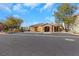 A community clubhouse showcases stone accents, a tile roof, and well-manicured landscaping at 7083 Mackenzie Bay Ave, Las Vegas, NV 89179