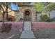 Inviting front entrance with a stone facade, tiled roof, and a well-maintained landscaped front yard at 7083 Mackenzie Bay Ave, Las Vegas, NV 89179