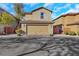 Two-car garage with a tile roof, complemented by tasteful landscaping and curb appeal at 7083 Mackenzie Bay Ave, Las Vegas, NV 89179