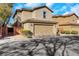 Two-car garage with a tile roof, complemented by tasteful landscaping and curb appeal at 7083 Mackenzie Bay Ave, Las Vegas, NV 89179