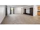 Spacious living room featuring neutral carpeting, built-in media center, and plenty of natural light at 7083 Mackenzie Bay Ave, Las Vegas, NV 89179