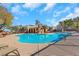 A luxurious community pool features a curved design and lounge chairs for relaxation at 7083 Mackenzie Bay Ave, Las Vegas, NV 89179