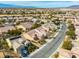 Panoramic aerial shot of a neighborhood with neatly arranged houses, mature trees, and pristine streets under a clear sky at 7757 Coast Jay St, North Las Vegas, NV 89084