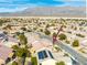 Aerial view of homes featuring solar panels in a well-planned community with desert mountain views under a bright, clear sky at 7757 Coast Jay St, North Las Vegas, NV 89084