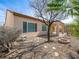 Backyard featuring desert landscaping, a covered patio, and a cozy fire pit area at 7757 Coast Jay St, North Las Vegas, NV 89084