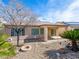 Landscaped backyard featuring a covered patio, desert plants and a fire pit at 7757 Coast Jay St, North Las Vegas, NV 89084