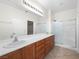 Bathroom with double sinks, spacious countertops, and a glass shower at 7757 Coast Jay St, North Las Vegas, NV 89084