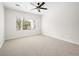 Bright and airy bedroom with neutral carpet, ceiling fan, and a large window providing natural light at 7757 Coast Jay St, North Las Vegas, NV 89084