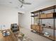 Virtually staged bedroom with desk, rug, ceiling fan and shelving at 7757 Coast Jay St, North Las Vegas, NV 89084