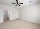 Spacious bedroom featuring a ceiling fan, carpeted floors, and a separate entrance to the bathroom at 7757 Coast Jay St, North Las Vegas, NV 89084