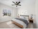 Staged bedroom with a ceiling fan, comfortable bed, neutral tones and natural light from the window at 7757 Coast Jay St, North Las Vegas, NV 89084