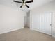 Neutral bedroom featuring carpet, ceiling fan, and closet with sliding doors at 7757 Coast Jay St, North Las Vegas, NV 89084