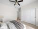 Bedroom after virtual staging, featuring carpet, ceiling fan, closet with sliding doors, bed and nightstand at 7757 Coast Jay St, North Las Vegas, NV 89084