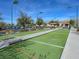 View of a well-maintained bocce ball court featuring smooth turf, clear lane markings and covered benches for relaxing with friends at 7757 Coast Jay St, North Las Vegas, NV 89084