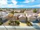 Overhead view of a single-Gathering home displaying a mature xeriscape, two car garage and tile roof at 7757 Coast Jay St, North Las Vegas, NV 89084