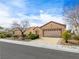 Charming single-story home features a well-manicured front yard and a two-car garage at 7757 Coast Jay St, North Las Vegas, NV 89084