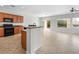 Bright kitchen featuring wood cabinets, black appliances, and an island with granite countertop in open floor plan at 7757 Coast Jay St, North Las Vegas, NV 89084