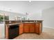 Kitchen island features wood cabinetry, granite counters, and a sink at 7757 Coast Jay St, North Las Vegas, NV 89084