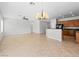 Bright living room featuring tile floors, an open layout, recessed lighting, and a kitchen with wood cabinets at 7757 Coast Jay St, North Las Vegas, NV 89084