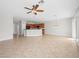 Spacious living room featuring tile flooring, ceiling fan, recessed lighting, and an open layout to the kitchen at 7757 Coast Jay St, North Las Vegas, NV 89084