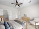 Bright main bedroom featuring a ceiling fan, neutral color palette, and ensuite bathroom at 7757 Coast Jay St, North Las Vegas, NV 89084