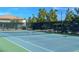 A view of community tennis court showcasing a well-maintained surface and sturdy net, perfect for recreational play at 7757 Coast Jay St, North Las Vegas, NV 89084