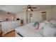 Comfortable bedroom featuring a fireplace, ceiling fan and elegant white furniture at 7905 Brent Leaf Ave, Las Vegas, NV 89131