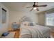 Bedroom featuring a large white bed with an upholstered headboard and bright, natural light at 7905 Brent Leaf Ave, Las Vegas, NV 89131