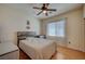 Cozy bedroom with wood floors, ceiling fan, and natural light at 7905 Brent Leaf Ave, Las Vegas, NV 89131