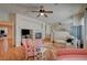 Inviting living room with a cozy fireplace, ceiling fan and comfortable pink furnishings at 7905 Brent Leaf Ave, Las Vegas, NV 89131