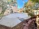 Private backyard showcasing a large patio, complemented by desert landscaping and access through sliding glass doors at 880 Glitter Glen Ct, Las Vegas, NV 89123