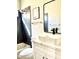 Modern bathroom featuring sleek black fixtures, white vanity and tile surround tub at 880 Glitter Glen Ct, Las Vegas, NV 89123