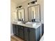 Bathroom featuring double sinks with updated fixtures, and neutral-colored cabinetry at 880 Glitter Glen Ct, Las Vegas, NV 89123