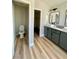 Bathroom featuring double sinks, neutral-colored cabinetry, toilet and closet at 880 Glitter Glen Ct, Las Vegas, NV 89123