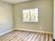 Cozy bedroom with hardwood floors and natural light streaming through the window at 880 Glitter Glen Ct, Las Vegas, NV 89123