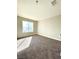 Bedroom featuring neutral walls, carpeting, and a bright window at 880 Glitter Glen Ct, Las Vegas, NV 89123