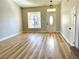 Bright entryway with wood-look floors, a stylish front door, and a light fixture at 880 Glitter Glen Ct, Las Vegas, NV 89123