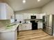 Spacious kitchen with white cabinets, stainless steel appliances, and wood-look flooring at 880 Glitter Glen Ct, Las Vegas, NV 89123