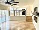 Bright living room with sliding glass doors and a view of the kitchen and modern fireplace at 880 Glitter Glen Ct, Las Vegas, NV 89123