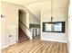 Open living room featuring wood-look flooring, contemporary lighting, and an accent wall at 880 Glitter Glen Ct, Las Vegas, NV 89123