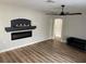 Bright living room featuring a fireplace, hardwood floors, and a modern ceiling fan at 880 Glitter Glen Ct, Las Vegas, NV 89123