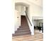 An interior shot of a carpeted staircase with modern railing and neutral wall paint at 880 Glitter Glen Ct, Las Vegas, NV 89123