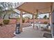 Backyard with a covered patio, desert landscaping, sitting area, and exterior lights at 9005 Meisenheimer Ave, Las Vegas, NV 89143