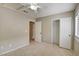 Neutral bedroom featuring tile floors, ceiling fan and light, with a closet and an ensuite bathroom at 9005 Meisenheimer Ave, Las Vegas, NV 89143