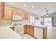 Functional kitchen featuring white appliances, light wood cabinetry, and tiled floors at 9005 Meisenheimer Ave, Las Vegas, NV 89143