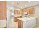 Functional kitchen featuring white appliances, light wood cabinetry, and tiled floors at 9005 Meisenheimer Ave, Las Vegas, NV 89143