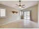 Neutral living space with tile floors, a rustic wood shelf, and sliding door access at 9005 Meisenheimer Ave, Las Vegas, NV 89143