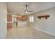 Neutral living space with tile floors, a rustic wood shelf, and kitchen access at 9005 Meisenheimer Ave, Las Vegas, NV 89143