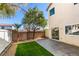 Backyard with patio area, artificial grass, and mature trees at 9102 Brilliant Prairie Ct, Las Vegas, NV 89149