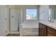 Bathroom featuring separate shower and tub with wood vanity at 9102 Brilliant Prairie Ct, Las Vegas, NV 89149